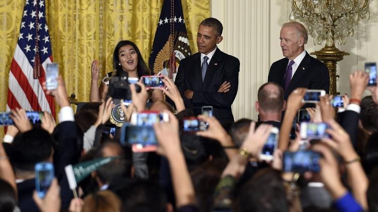 President Obama and Vice President Biden listen as Diana Calderon, a student who has benefited from the Deferred Action for Childhood Arrivals (DACA) program, speaks at a reception in the White House on Oct. 15. (Susan Walsh / Associated Press)