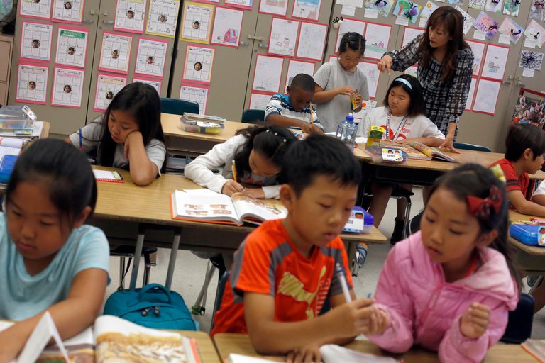 Wonnie Pak, a teacher, working with third graders in a Korean dual-language program at Cahuenga Elementary School in Los Angeles. CreditIvan Kashinsky for The New York Times 