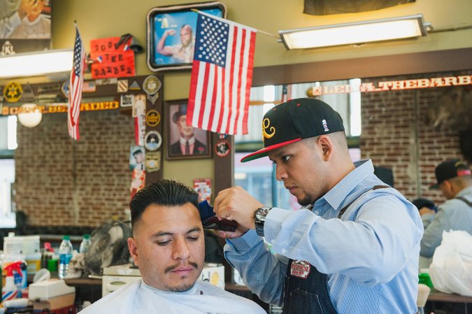 The American Barber Shop on Calle Cuatro in Santa Ana. Credit, Andrew Cullen for The New York Times 