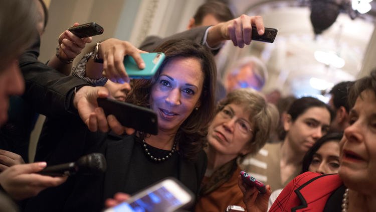 Sen.-elect Kamala Harris (D-Calif.) finds herself surrounded by reporters questioning Sen. Dianne Feinstein. (Tom Williams / CQ Roll Call